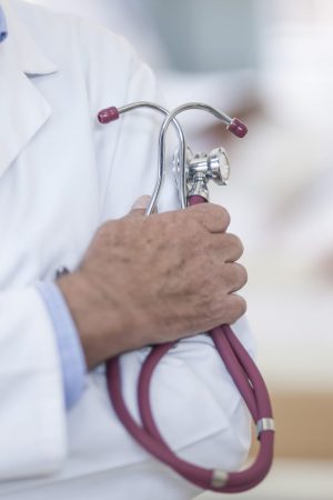 Close-up of doctor in hospital holding stethoscope