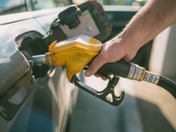 Car refueling on petrol station. Man pumping gasoline oil. This photo can be used for automotive industry or transportation concept