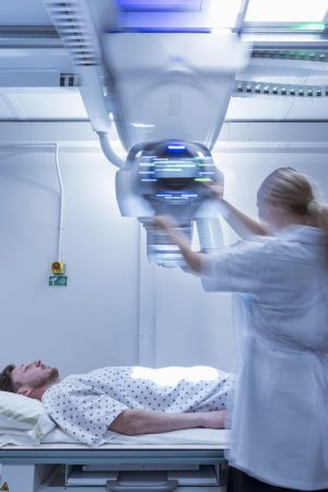 Radiologist setting up x-ray machine in hospital