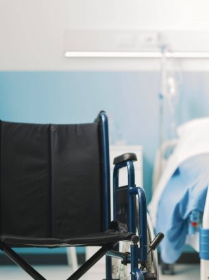 Wheelchair in a hospital ward: disability and healthcare concept
